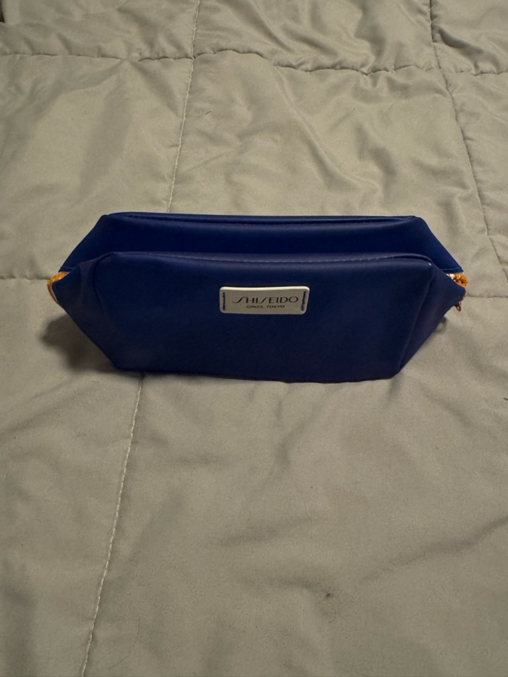 Shiseido Men’s Blue Toiletry Pouch with Orange Accents